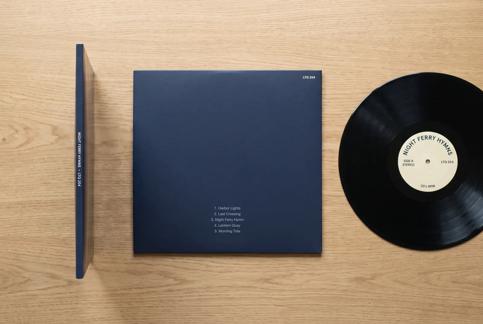 Illustration of a fictional vinyl LP, Night Ferry Hymns, with the catalog number LTQ 204 on the sleeve’s spine, in the top right corner of the back cover and on the side A center label